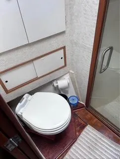 Slide: The Image of 1986 Egg Harbor 60 Sportfisherman bathroom with toilet and shower. - 12