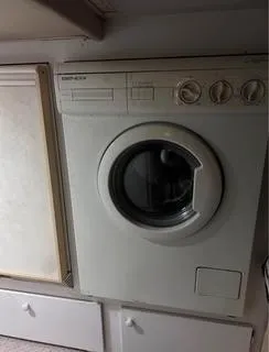 Slide: The Image of 1986 Egg Harbor 60 Sportfisherman interior with built-in washing machine. - 15