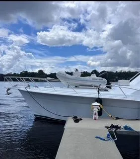 Slide: The Image of 1986 Egg Harbor 60 Sportfisherman docked under a partly cloudy sky. - 3