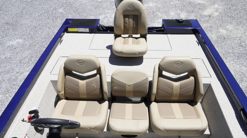 Slide: The Image of 2025 G3 Sportsman 1710 boat interior with beige seating and steering wheel. - 12