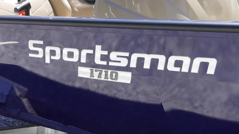 Slide: The Image of 2025 G3 Sportsman 1710 boat logo on dark blue surface. - 25