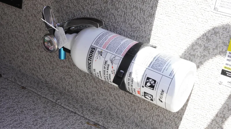 Slide: The Image of Fire extinguisher mounted on 2025 G3 Sportsman 1710 boat interior. - 36