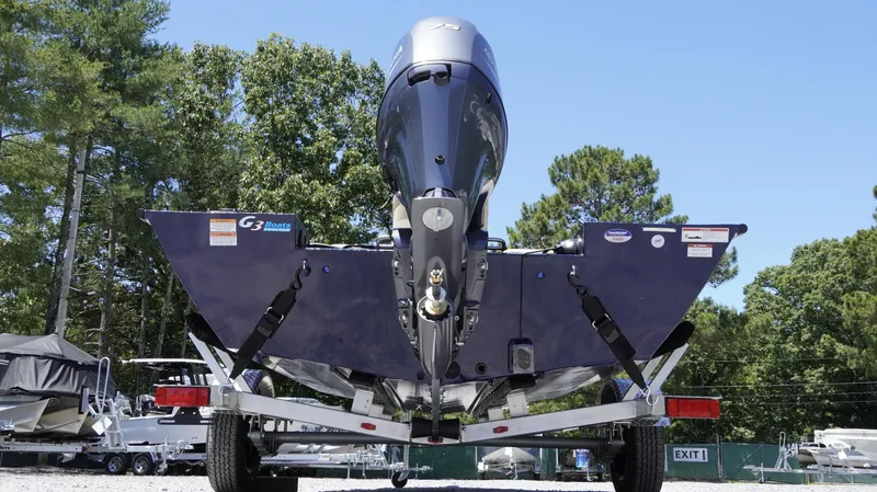 Slide: The Image of 2025 G3 Sportsman 1710 boat on trailer, rear view, outdoors with trees in background. - 39