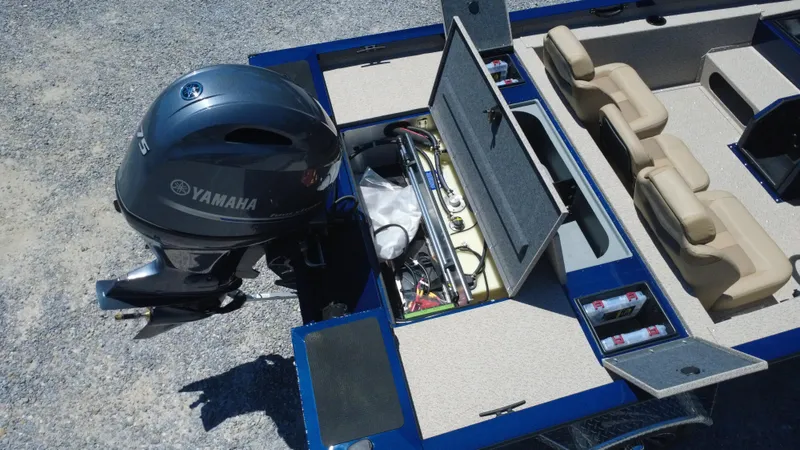 Slide: The Image of 2025 G3 Sportsman 1710 boat with Yamaha motor, open storage compartments, and beige seating. - 42