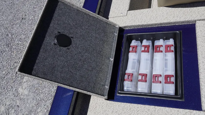 Slide: The Image of Storage compartment in 2025 G3 Sportsman 1710 boat with organized tackle boxes. - 6