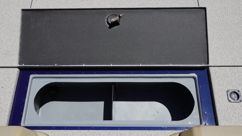 Slide: The Image of 2025 G3 Sportsman 1710 boat storage compartment with open lid and lock mechanism. - 7