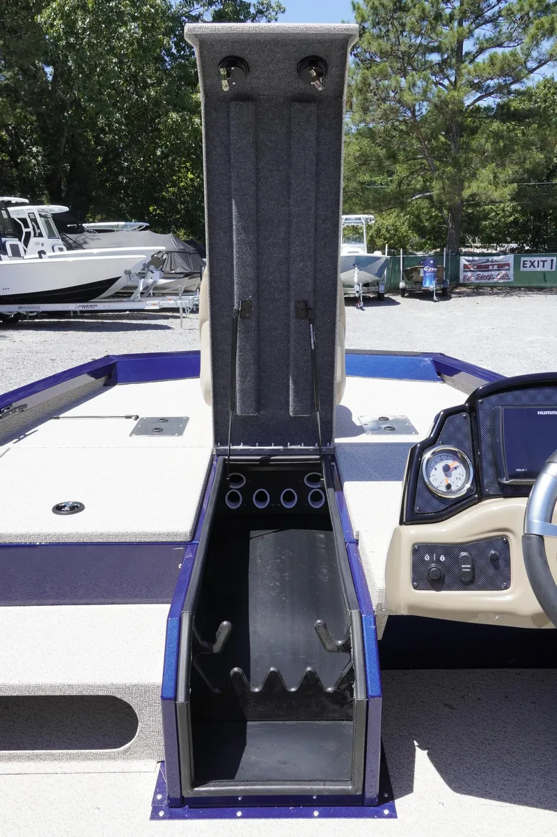 Slide: The Image of 2025 G3 Sportsman 1710 boat with open storage compartment and control panel. - 9