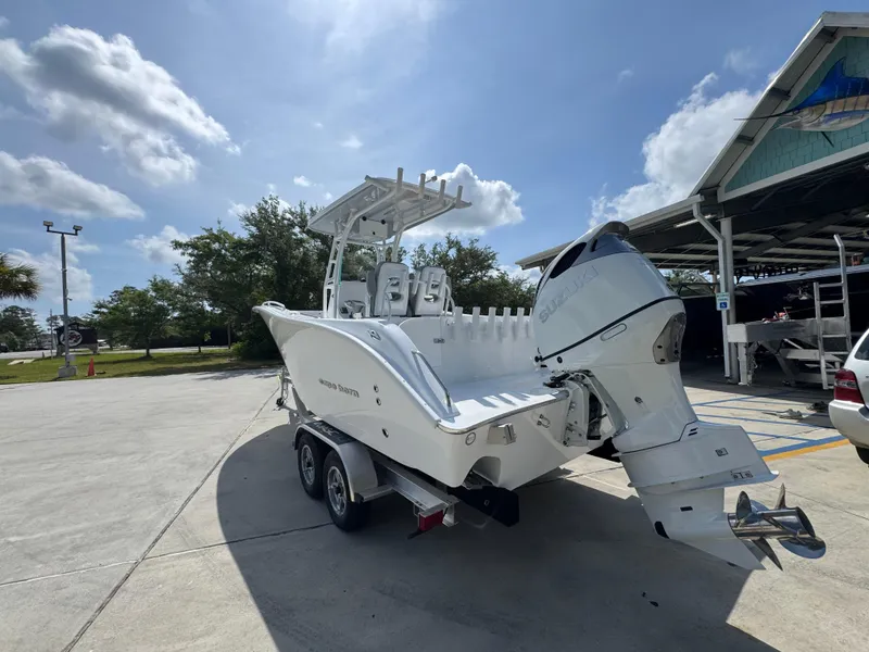 Slide: The Image of 2025 Cape Horn 22 OS boat on trailer under sunny sky. - 16