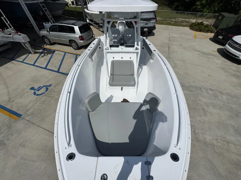 Slide: The Image of 2025 Cape Horn 22 OS boat with spacious seating and modern design in a parking lot. - 20