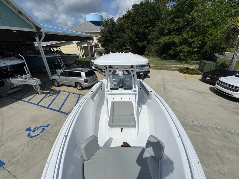 Slide: The Image of 2025 Cape Horn 22 OS boat in a parking lot, showcasing sleek design and spacious seating. - 21