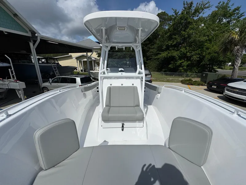 Slide: The Image of 2025 Cape Horn 22 OS boat interior with seating and console under a clear sky. - 22