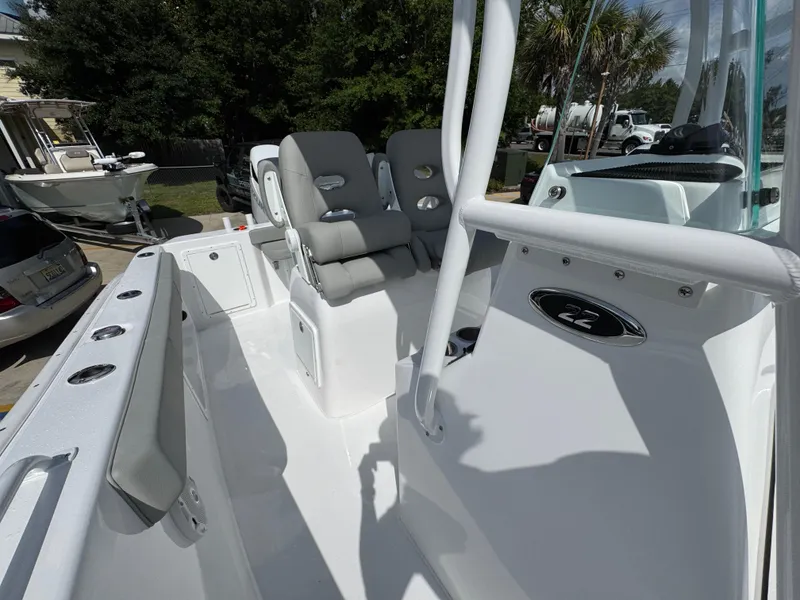 Slide: The Image of 2025 Cape Horn 22 OS boat interior with seating and console, showcasing modern design and features. - 28