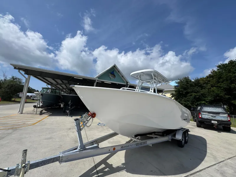 Slide: The Image of 2025 Cape Horn 22 OS boat on trailer under a partly cloudy sky. - 3