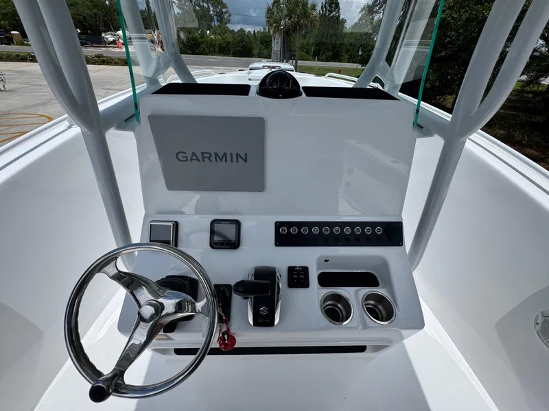 Slide: The Image of 2025 Cape Horn 22 OS boat console with Garmin navigation system and steering wheel. - 31