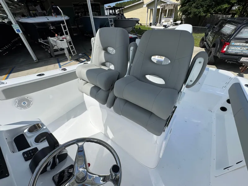 Slide: The Image of 2025 Cape Horn 22 OS boat with dual gray captain's chairs and steering wheel. - 34