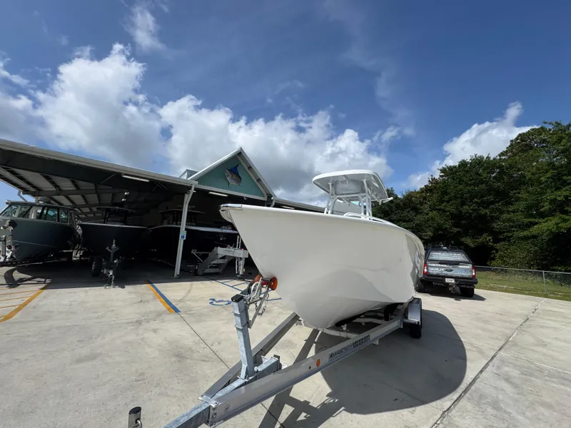 Slide: The Image of 2025 Cape Horn 22 OS boat on trailer under clear blue sky. - 4