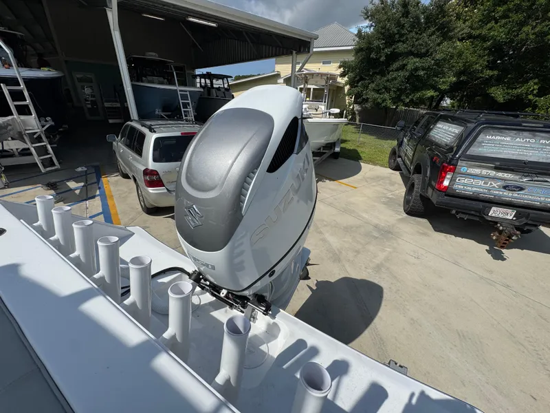 Slide: The Image of 2025 Cape Horn 22 OS boat with Suzuki outboard motor in a parking area. - 41