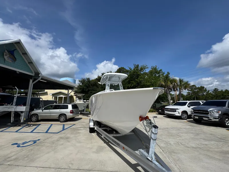 Slide: The Image of 2025 Cape Horn 22 OS boat on trailer in parking lot under blue sky. - 7