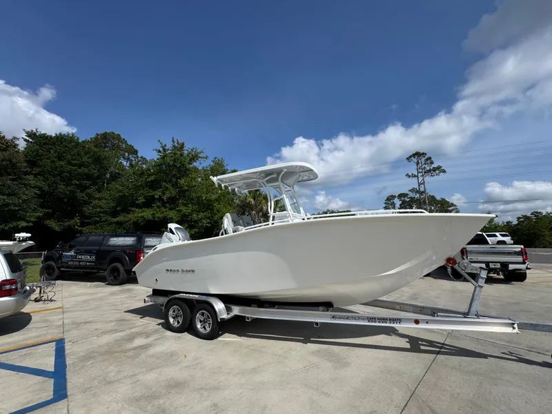 Slide: The Image of 2025 Cape Horn 22 OS boat on trailer in sunny outdoor setting. - 9