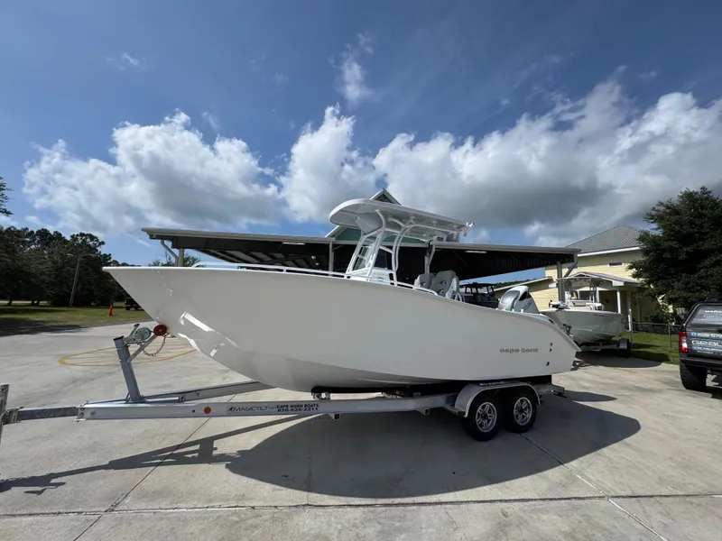Slide: The Image of 2025 Cape Horn 22 OS boat on trailer under clear sky. - 1