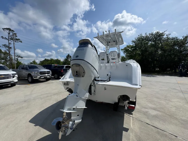 Slide: The Image of 2025 Cape Horn 22 OS boat with outboard motor in a parking lot. - 13