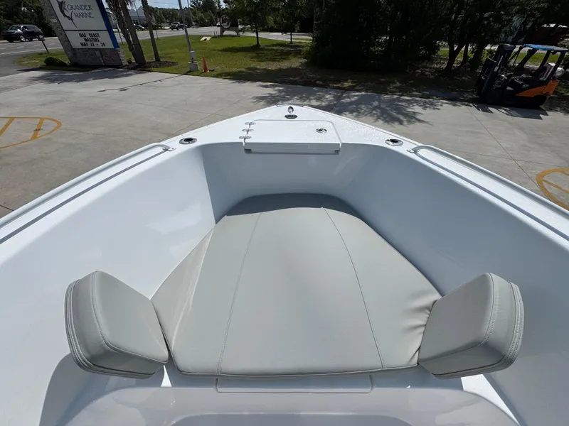 Slide: The Image of 2025 Cape Horn 22 OS boat bow with cushioned seating in a marina setting. - 19