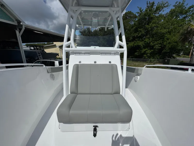 Slide: The Image of 2025 Cape Horn 22 OS boat with gray seating and white console, docked outdoors. - 23