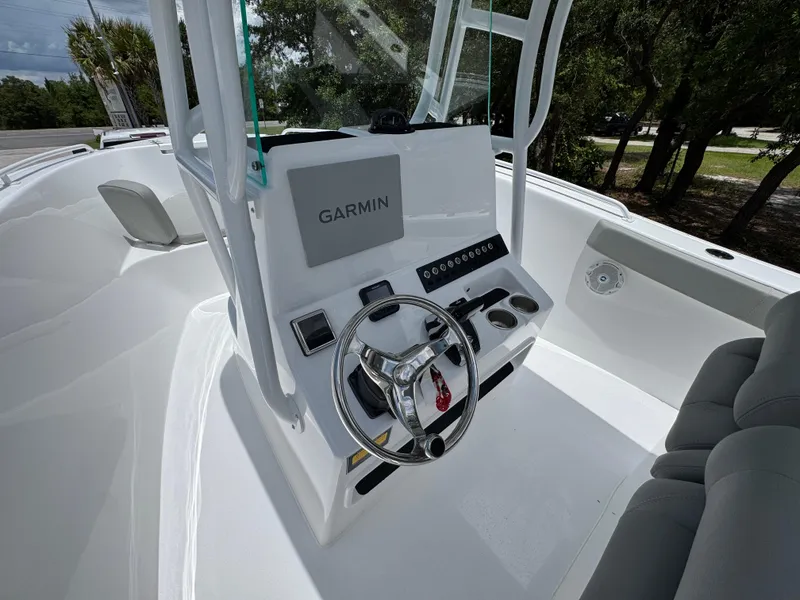 Slide: The Image of 2025 Cape Horn 22 OS boat cockpit with Garmin navigation system and steering wheel. - 30