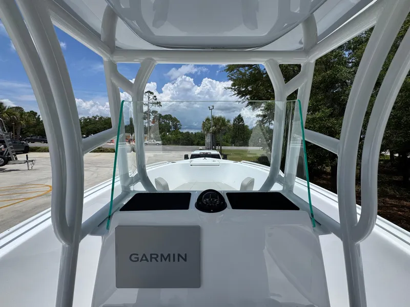 Slide: The Image of 2025 Cape Horn 22 OS boat with Garmin navigation, docked under a clear blue sky. - 32