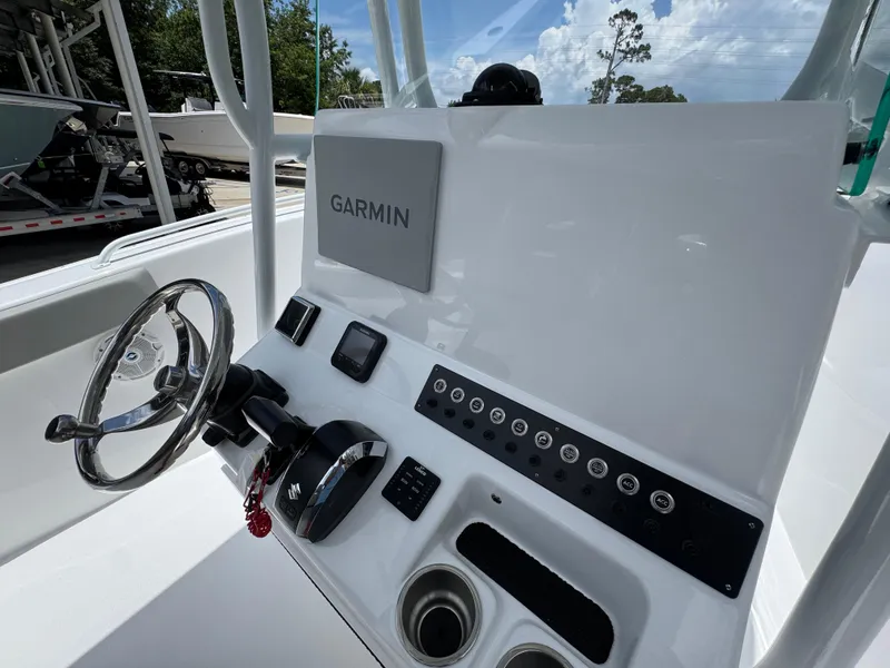 Slide: The Image of 2025 Cape Horn 22 OS boat console with Garmin navigation system and steering wheel. - 33