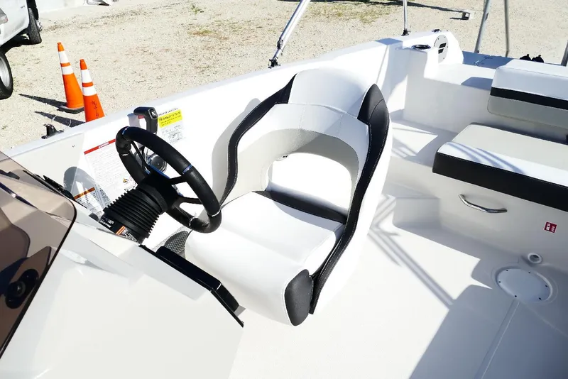Slide: The Image of 2026 Starcraft SVX 211 OB boat interior with steering wheel and seating. - 13
