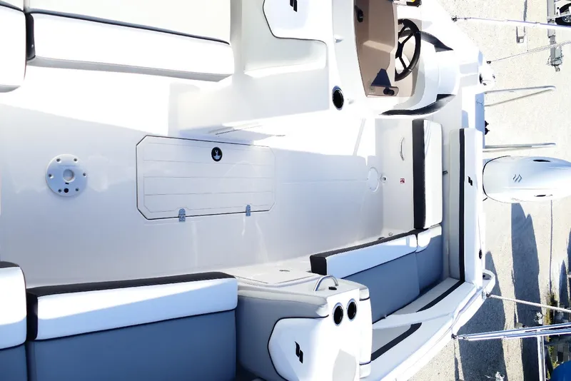 Slide: The Image of 2026 Starcraft SVX 211 OB boat interior with seating and steering wheel. - 22