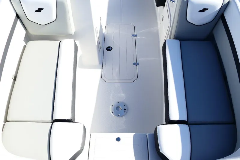 Slide: The Image of 2026 Starcraft SVX 211 OB boat interior with white and gray seating. - 24