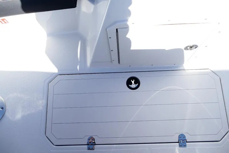 Slide: The Image of 2026 Starcraft SVX 211 OB boat storage compartment with latch and shadow detail. - 27