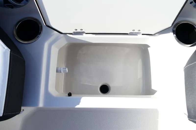 Slide: The Image of 2026 Starcraft SVX 211 OB boat storage compartment with cup holders. - 29