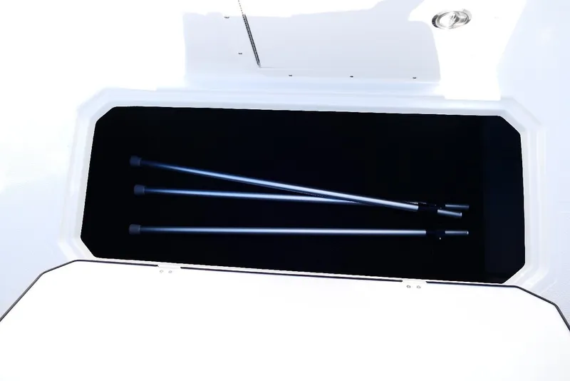 Slide: The Image of Storage compartment of 2026 Starcraft SVX 211 OB boat with metal poles inside. - 31
