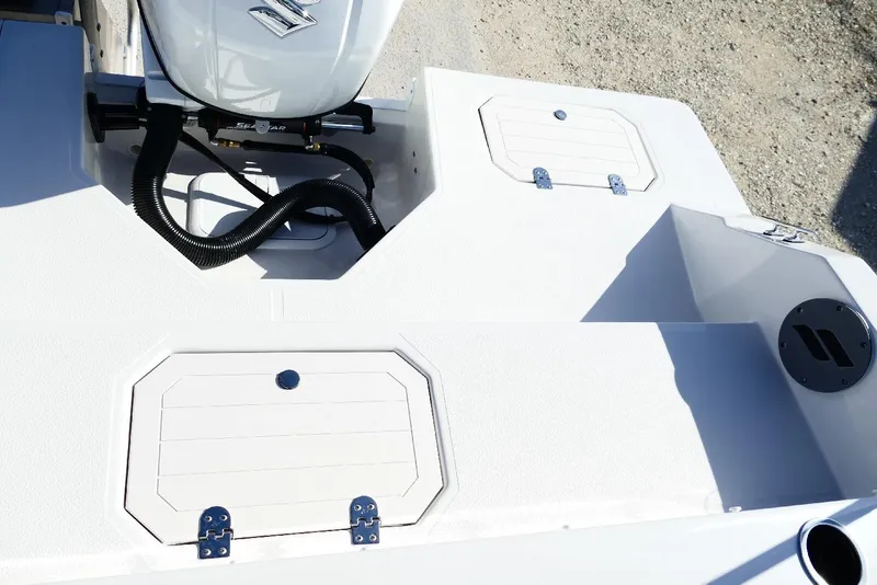 Slide: The Image of 2026 Starcraft SVX 211 OB boat deck with storage compartments and engine. - 32