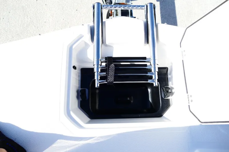 Slide: The Image of 2026 Starcraft SVX 211 OB boat ladder compartment with stainless steel ladder and open hatch. - 36