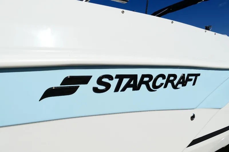 Slide: The Image of 2026 Starcraft SVX 211 OB boat logo on white and blue hull. - 4
