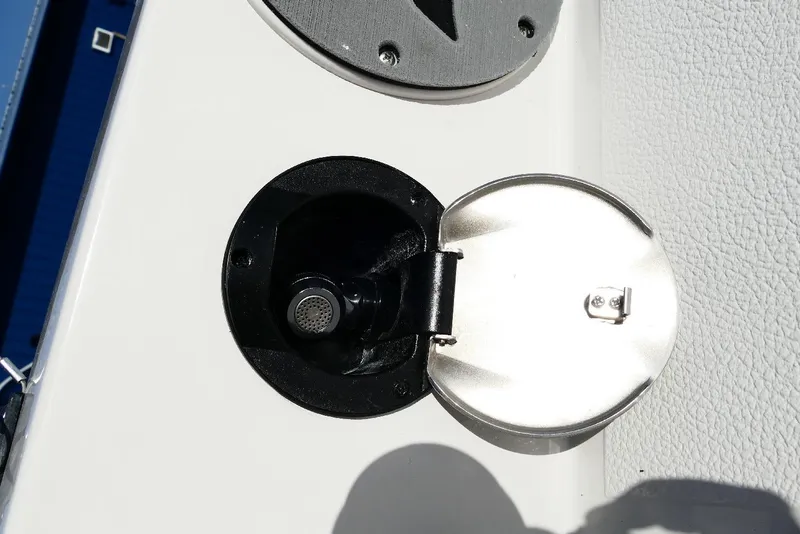 Slide: The Image of Fuel cap on 2026 Starcraft SVX 211 OB boat, open with metal cover. - 41