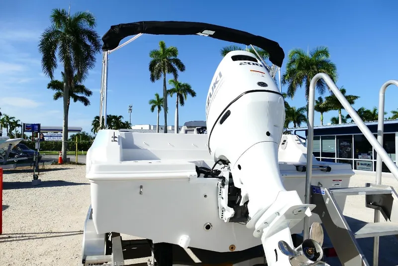 Slide: The Image of 2026 Starcraft SVX 211 OB boat with Suzuki outboard motor, displayed outdoors with palm trees. - 5