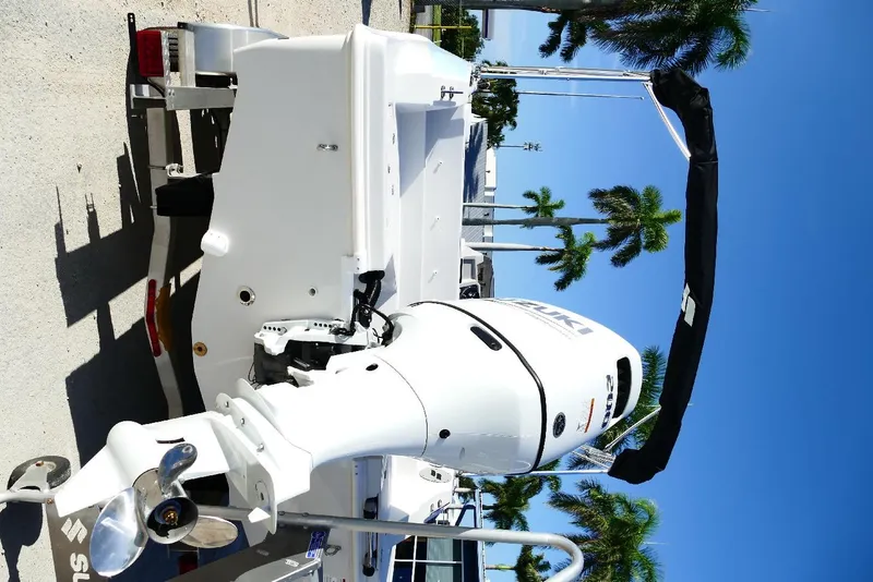 Slide: The Image of 2026 Starcraft SVX 211 OB boat with Suzuki outboard motor, parked under clear blue sky. - 6