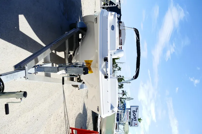 Slide: The Image of 2026 Starcraft SVX 211 OB boat on trailer under clear blue sky. - 8
