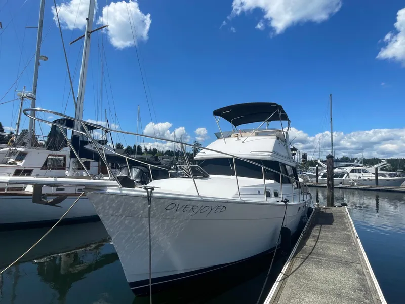 Slide: The Image of 1993 Bayliner 3288 Motoryacht on trailer, docked at marina, overcast sky. - 2