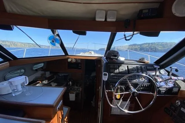 Slide: The Image of Interior view of 1993 Bayliner 3288 Motoryacht cockpit with steering wheel and navigation equipment. - 5