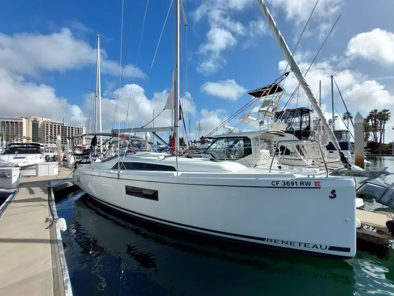 Slide: The Image of 2020 Beneteau Oceanis 30.1 sailboat docked in a marina under a blue sky. - 0
