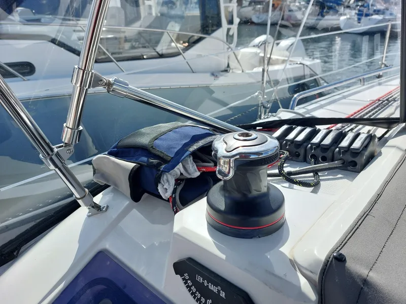 Slide: The Image of Winch and ropes on a 2020 Beneteau Oceanis 30.1 sailboat deck in a marina. - 11