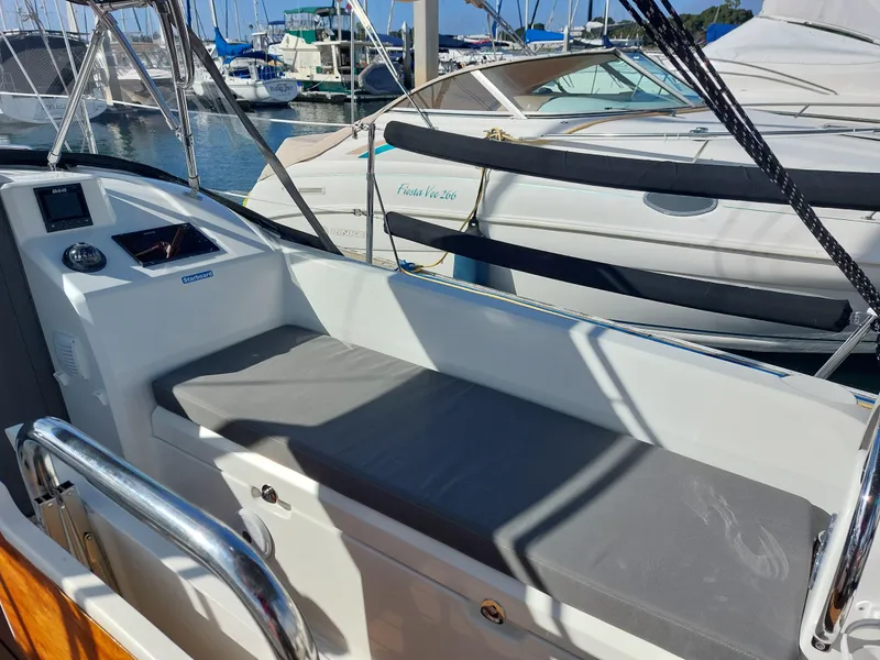 Slide: The Image of Beneteau Oceanis 30.1 sailboat cockpit, 2020 model, docked at marina with other boats. - 13