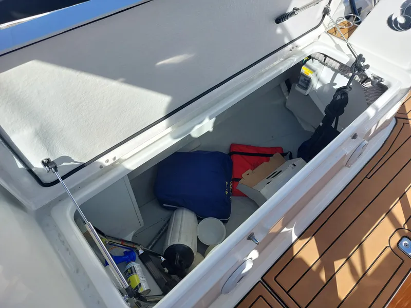 Slide: The Image of Storage compartment on a 2020 Beneteau Oceanis 30.1 sailboat, containing various boating equipment. - 15