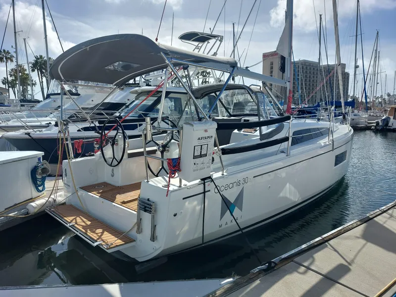 Slide: The Image of 2020 Beneteau Oceanis 30.1 sailboat docked at marina, sunny day. - 2